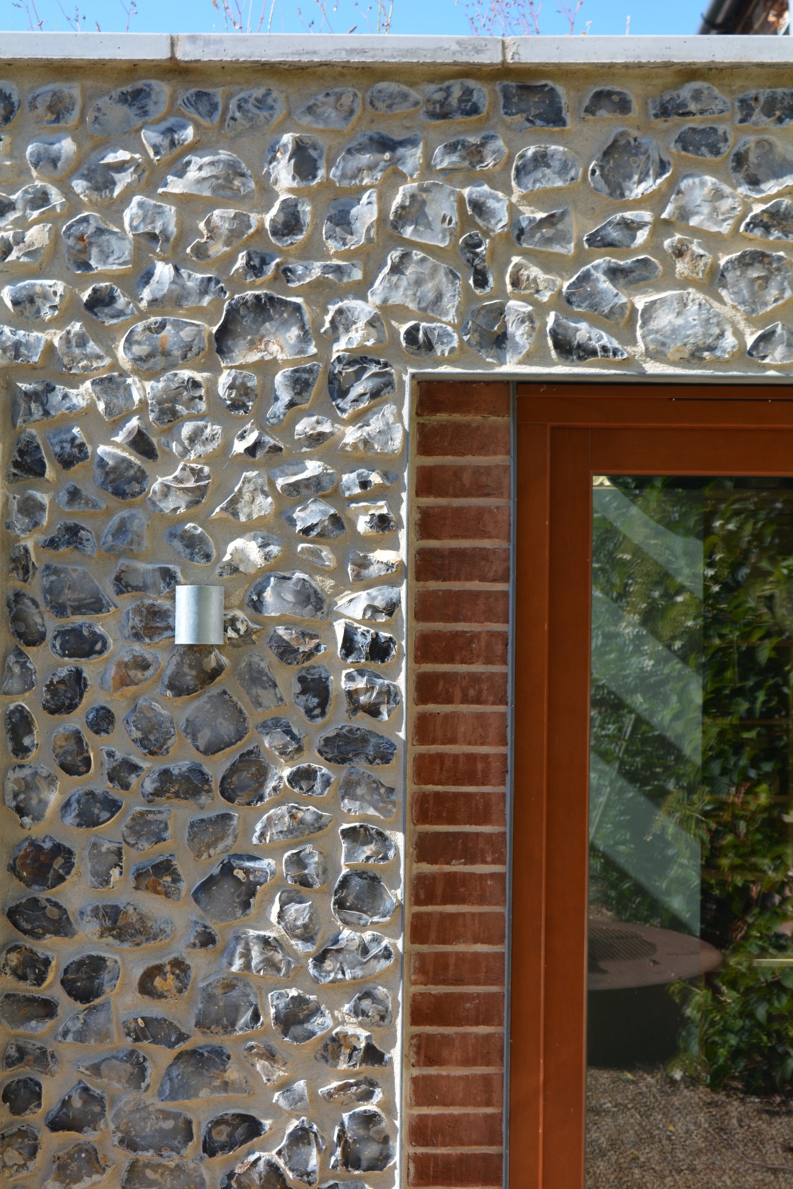 Close-up of flint and brick exterior detail around a window